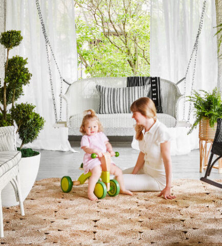 A child riding a tricycle indoors